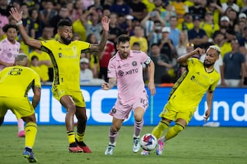 Lionel Messi (C) dribbles between Nashville SC midfielders Anibal Godoy (L) and Hany Mukhtar (R) during the second half of the 2023 Leagues Cup final between Nashville SC and Inter Miami CF.